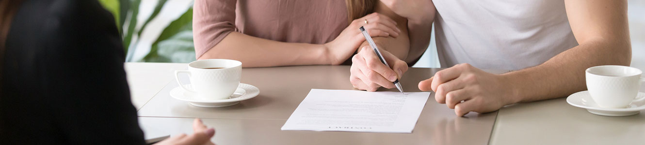 Couple signing a contract for a loan