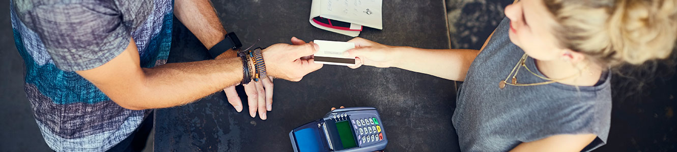 Man using a credit or debit card in a store