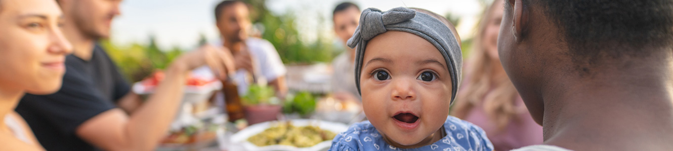 Friends with a baby at a picnic