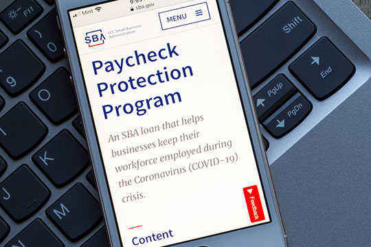 A cell phone that has the Paycheck Protection Program pulled up for SBA loans