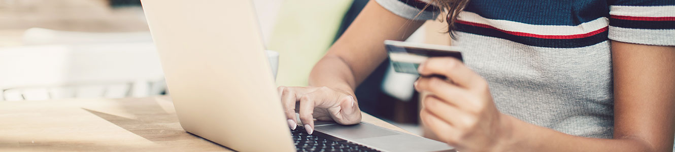 Lady using credit or debit card on a laptop computer