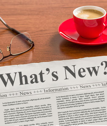 Newspaper on a desk that says "What's New?"