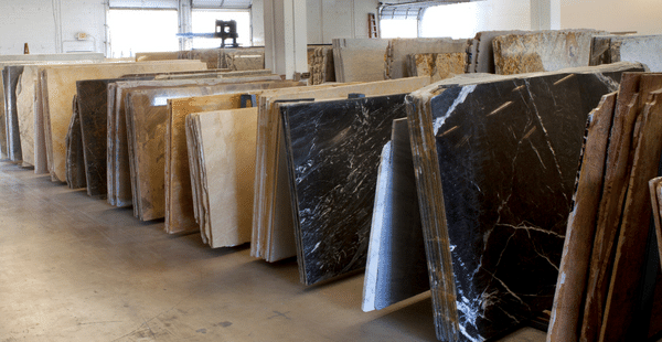 A row of different granite counter cabinets that are in a shop