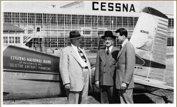 1950 photo from CNB STL with employees standing in front of Citizens Bank branded airplane