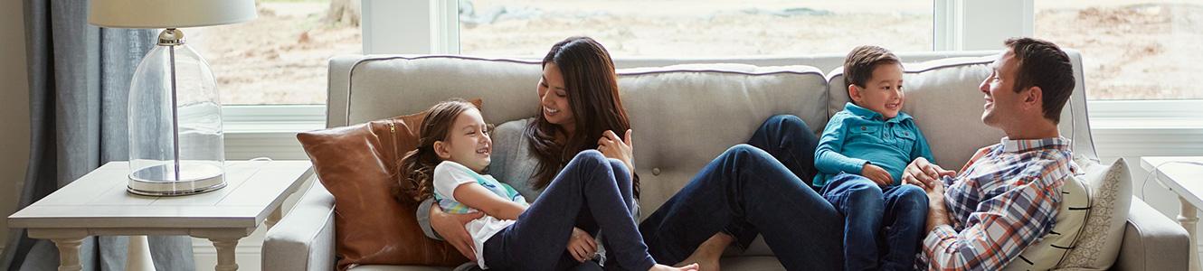 Family sitting on a sofa talking