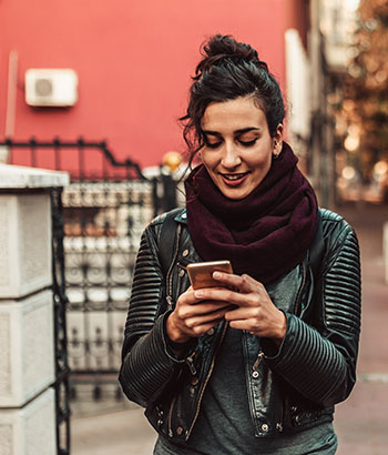 Lady looking at her smartphone on the street