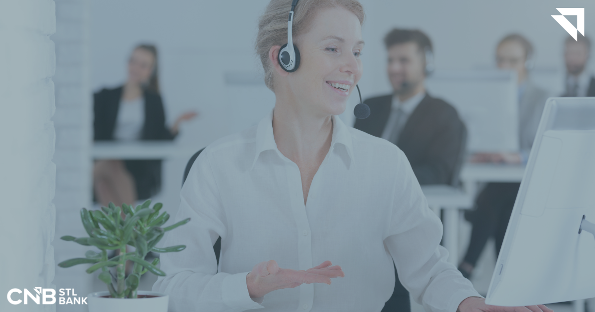 A woman talking on the phone with a customer at work. 