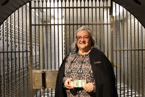 Mary Piles historian and archivist at CNB St. Louis Bank in front of bank vault