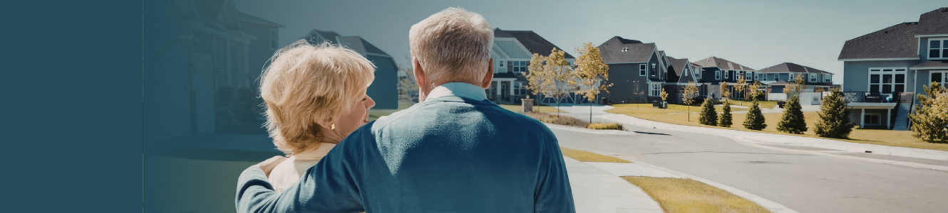 Man and woman looking out at homes